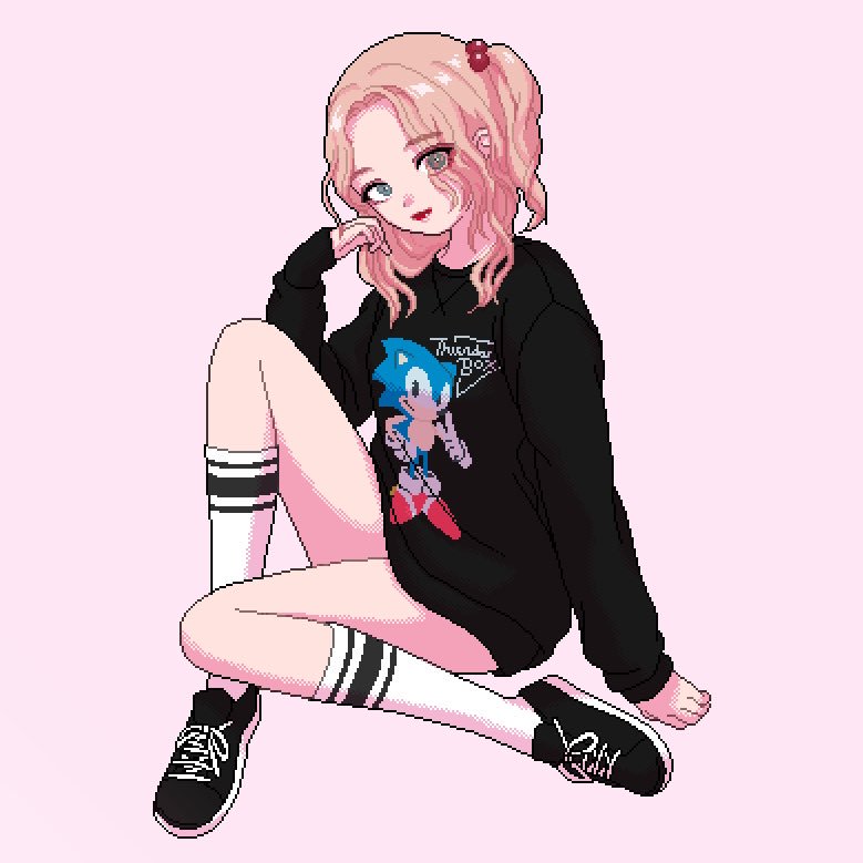 narume, sonic the hedgehog, sonic (series), commentary, english commentary, 1girl, ankle socks, black shoes, black sleeve cuffs, black sleeves, black sweater, character print, english text, eyes visible through hair, full body, grey eyes, hair bobbles, hair intakes, hair ornament, laces, lipstick, looking at viewer, makeup, medium hair, official alternate costume, one side up, parted bangs, pink hair, print sweater, red lips, shoes, sitting, sleeve cuffs, smile, sneakers, socks, solo, sweater, wavy hair, white socks
