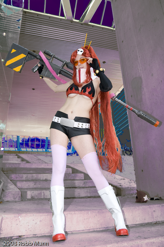 ellarcy, yoko littner, tengen toppa gurren lagann, visor, cosplay photo, photo (medium), 1girl, adjusting eyewear, adjusting glasses, belt, bikini, bikini top only, black bikini, boots, breasts, cleavage, cosplay, elbow gloves, female focus, fingerless gloves, glasses, gloves, gun, long hair, orange-tinted eyewear, orange-tinted glasses, ponytail, red hair, safety glasses, short shorts, shorts, skull, solo, studded belt, sunglasses, swimsuit, thighhighs, tinted eyewear, underboob, weapon