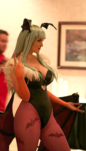 lindze, morrigan aensland, capcom, darkstalkers, real life, cosplay photo, lowres, photo (medium), 1girl, animal print, bat print, bat wings, blunt bangs, blurry, breasts, cosplay, depth of field, female focus, from side, head wings, large breasts, leotard, low wings, morrigan aensland (cosplay), pantyhose, patterned legwear, picture frame, print pantyhose, solo, thighs, wings