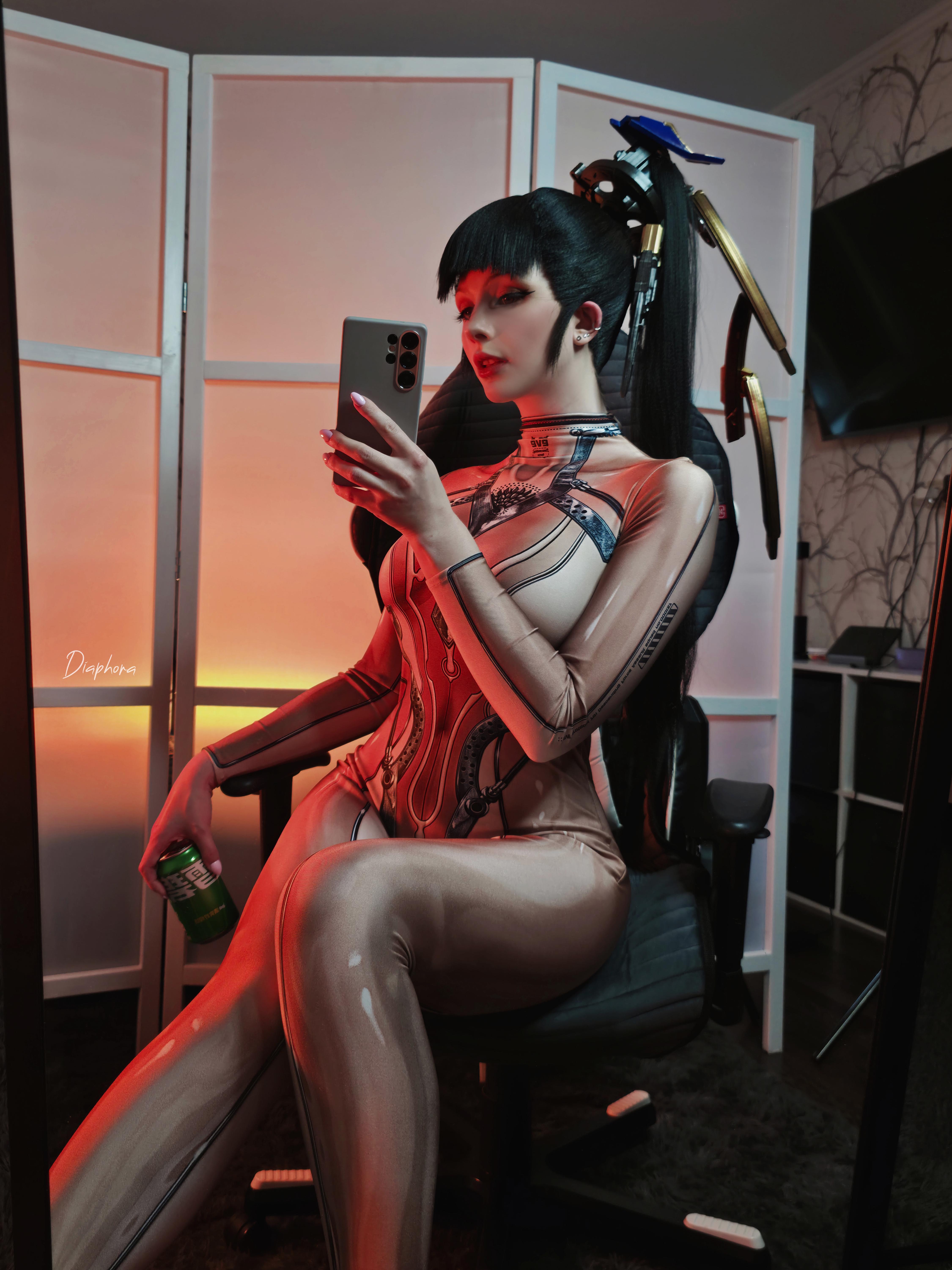 diaphora, eve (stellar blade), real life, stellar blade, absurdres, cosplay photo, highres, photo (medium), 1girl, black hair, can, cellphone, chair, cosplay, eve (stellar blade) (cosplay), female focus, holding, holding can, holding phone, indoors, phone, ponytail, selfie, sitting, skin suit (stellar blade), smartphone, solo