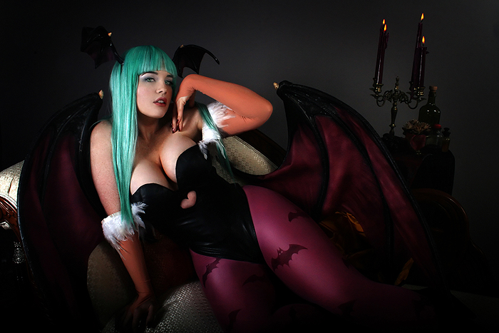 lindze, morrigan aensland, capcom, darkstalkers, cosplay photo, photo (medium), breasts, candle, cleavage, cosplay, couch, dark, demon girl, elbow gloves, freckles, gloves, green eyes, green hair, head wings, large breasts, lips, lipstick, long hair, makeup, morrigan aensland (cosplay), pantyhose, solo, wings