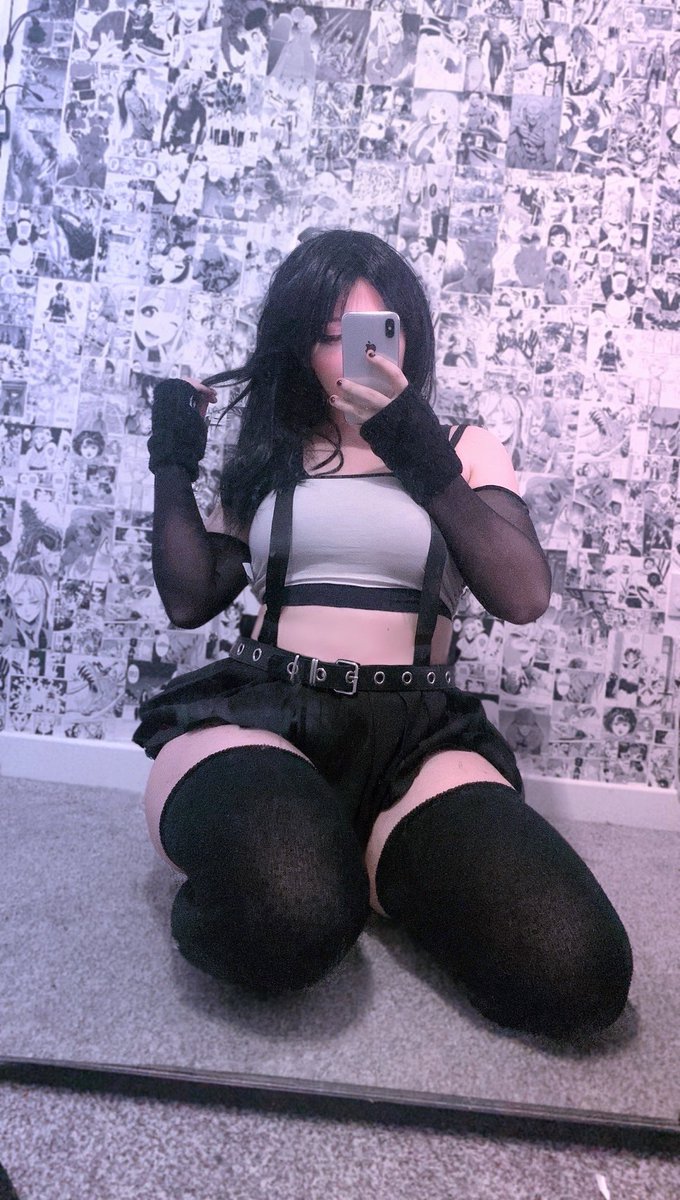 ny4ncy, tifa lockhart, final fantasy, final fantasy vii, final fantasy vii remake, real life, square enix, cosplay photo, photo (medium), 1girl, bare shoulders, black gloves, black hair, black skirt, black thighhighs, cellphone, female focus, gloves, hand in own hair, holding, holding phone, long hair, phone, selfie, sitting, skirt, smartphone, solo, suspender skirt, suspenders, thighhighs, tifa lockhart (cosplay), wariza