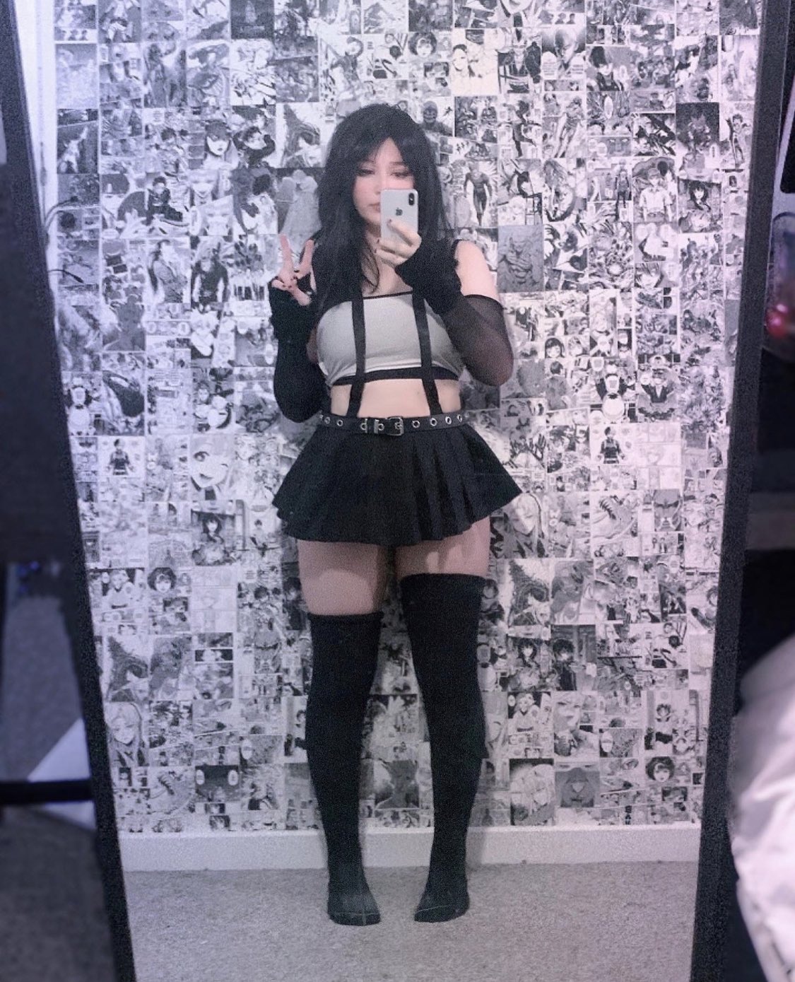 ny4ncy, tifa lockhart, final fantasy, final fantasy vii, final fantasy vii remake, real life, square enix, cosplay photo, highres, photo (medium), 1girl, bare shoulders, black gloves, black hair, black skirt, black thighhighs, cellphone, female focus, gloves, holding, holding phone, long hair, phone, selfie, skirt, smartphone, solo, suspender skirt, suspenders, thighhighs, tifa lockhart (cosplay), v