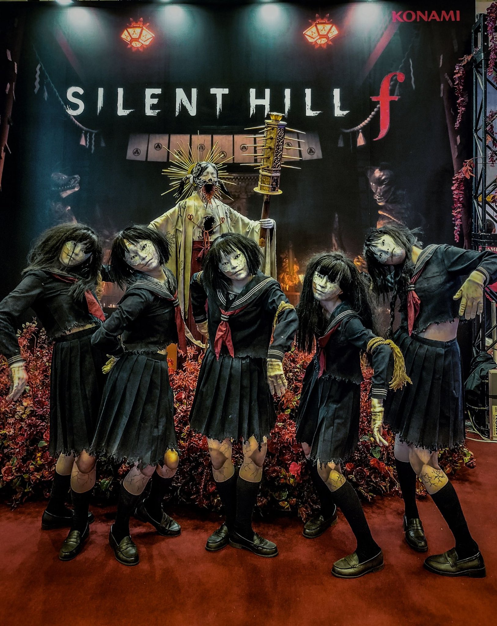 ayakakashi, priestess sakuko, konami, real life, silent hill (series), silent hill f, highres, photo (medium), 6+girls, ayakakashi (cosplay), bent over, black eyes, black hair, black serafuku, black shirt, black skirt, breasts, cosplay, expressionless, full body, japanese (nationality), logo, midriff, monster girl, multiple girls, navel, neckerchief, photo (object), red neckerchief, rope, rope marks, school uniform, serafuku, shirt, short hair, skirt, torn clothes, torn shirt, torn skirt, underboob