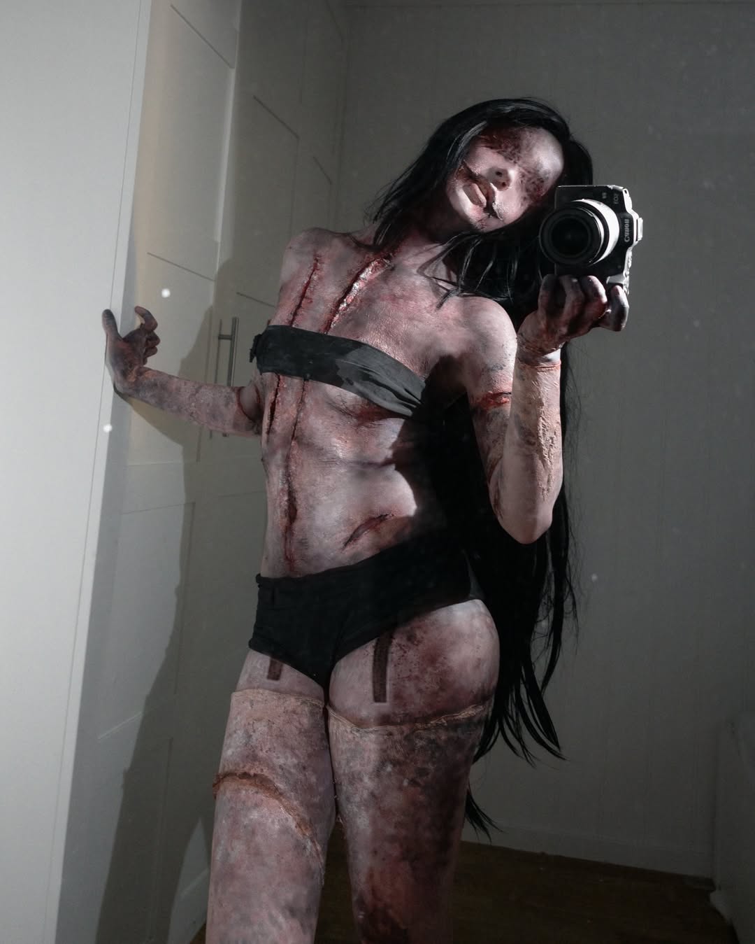 kashimashi (silent hill), real life, silent hill (series), silent hill f, highres, photo (medium), 1girl, black hair, breasts, cosplay, curvy, ezcosplay, indoors, injury, kashimashi (silent hill) (cosplay), long hair, monster girl, navel, no eyes, parted lips, selfie, small breasts, wide hips