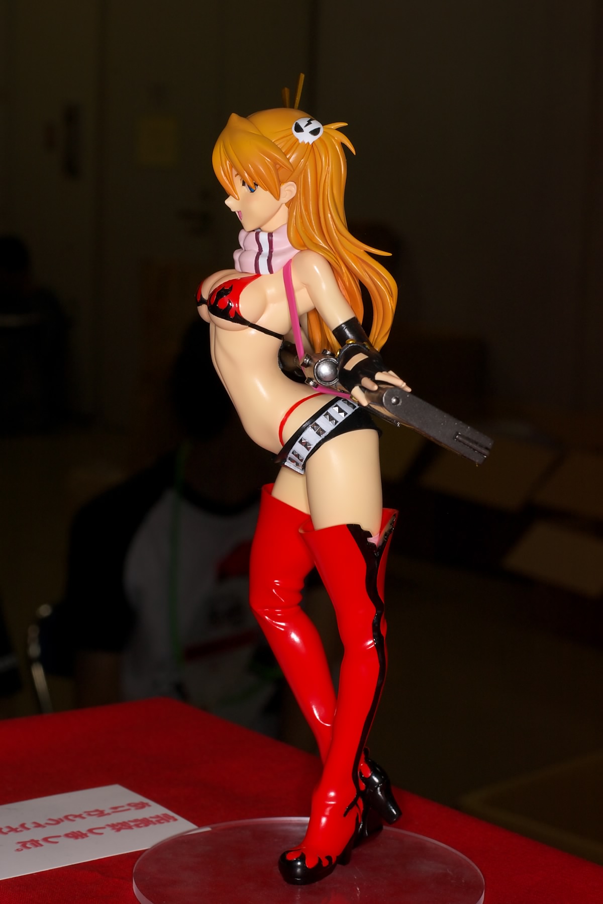 souryuu asuka langley, yoko littner, neon genesis evangelion, tengen toppa gurren lagann, wonder festival, wonder festival 2008, highres, photo (medium), 1girl, arched back, belt, bikini, bikini top only, blue eyes, boots, breasts, chopsticks, cosplay, female focus, figure, figure (medium), fingerless gloves, gloves, gun, hair ornament, long hair, orange hair, panties, profile, red hair, rifle, scarf, short shorts, shorts, skull, skull hair ornament, solo, standing, studded belt, swimsuit, thigh boots, thighhighs, thong, underboob, underwear, weapon, whale tail (clothing), yoko littner (cosplay)
