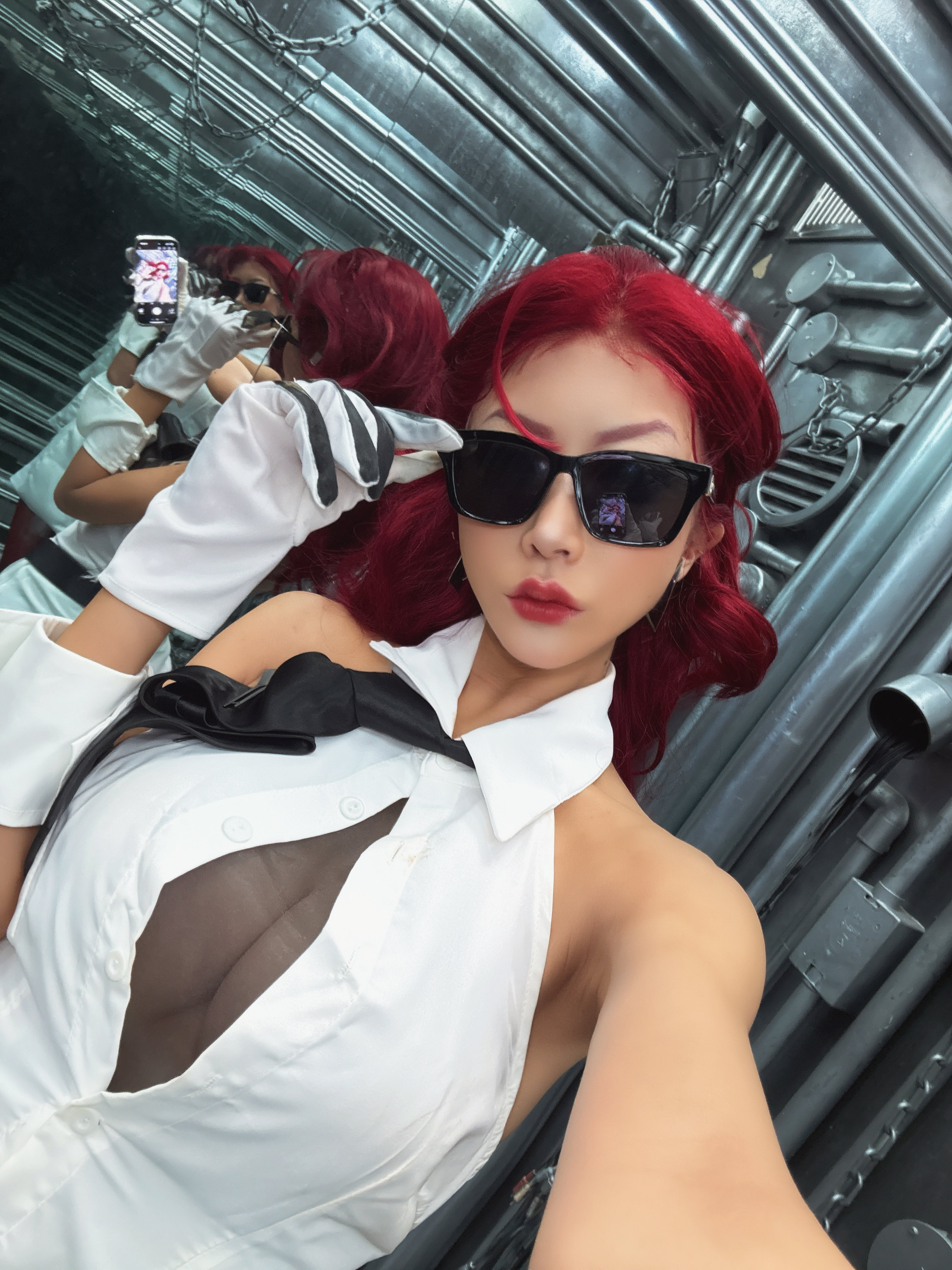 crimson viper, capcom, real life, street fighter, street fighter 6, cosplay photo, photo (medium), 1girl, atata dayo, bare shoulders, belt, black-tinted eyewear, breasts, coat, coat on shoulders, cosplay, crimson viper (cosplay), female focus, glasses, hair slicked back, long hair, red hair, reflection, solo, tinted eyewear, white coat, white wrist cuffs, wrist cuffs