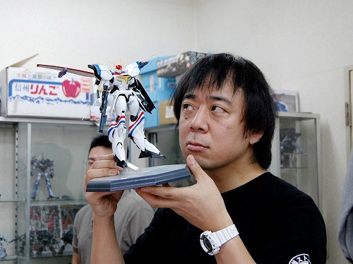 oobari masami, real life, lowres, photo (medium), 1boy, action figure, animator, anime designer, asian, director, dragonar, figure, garage kit, japanese (nationality), male focus, mecha, robot, sculpture, solo, watch