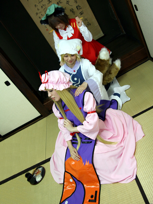 chen, yakumo ran, yakumo yukari, touhou, cosplay photo, photo (medium), 3girls, animal hat, cosplay, female focus, hanging scroll, hat, long sleeves, mob cap, multiple girls, scroll, short hair, tassel, tatami, wide sleeves