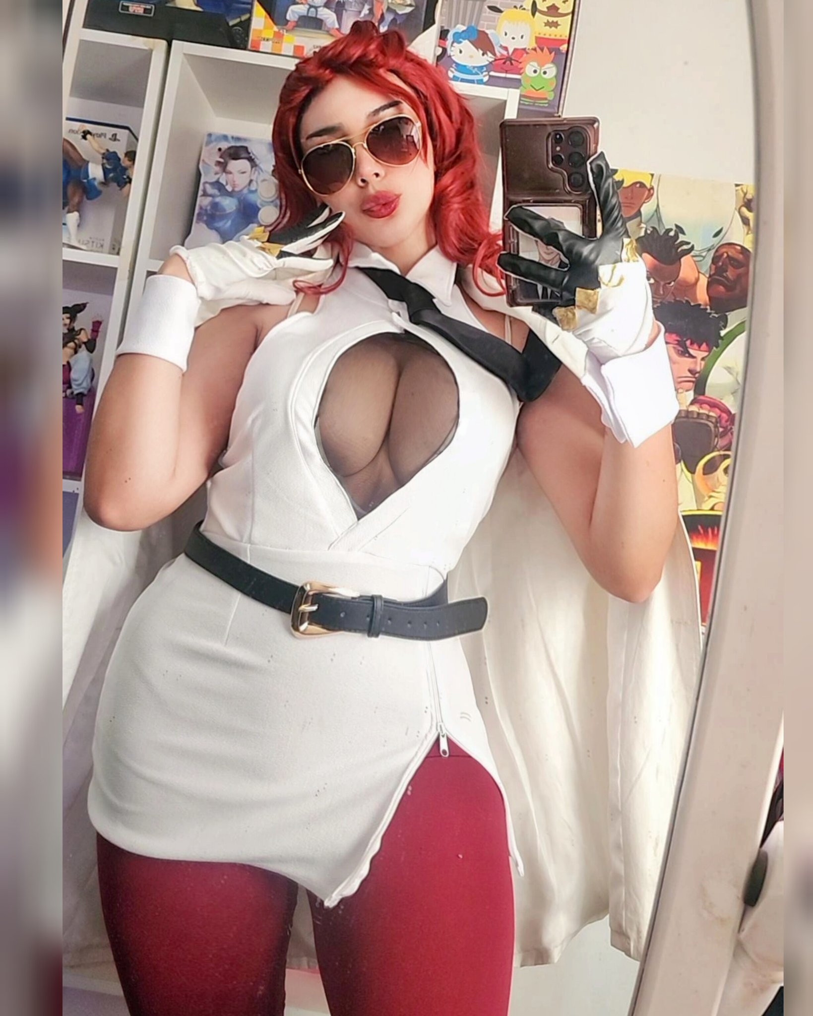 missyle fg, crimson viper, capcom, real life, street fighter, street fighter 6, cosplay photo, highres, photo (medium), 1girl, breasts, cellphone, coat, coat on shoulders, crimson viper (cosplay), female focus, gloves, hair slicked back, holding, holding phone, indoors, large breasts, lips, phone, red hair, selfie, side slit, smartphone, solo, tinted eyewear, white coat