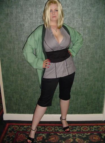 tsunade (naruto), naruto (classic), naruto (series), cosplay photo, photo (medium), 1girl, blonde hair, breasts, cleavage, cosplay, female focus, hands on own hips, huge breasts, long hair, sandals, shoes, solo, tsunade (naruto) (cosplay)