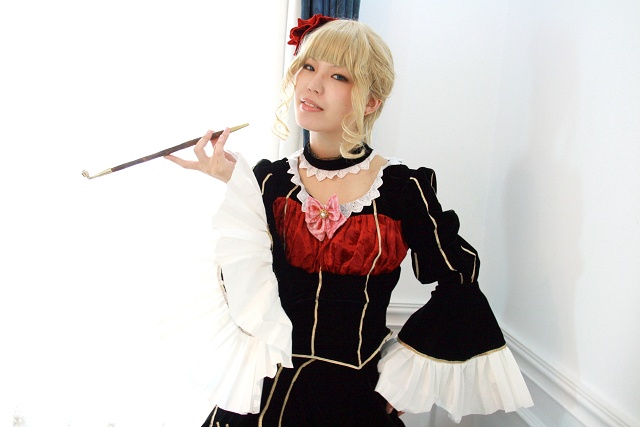 beatrice (umineko), umineko no naku koro ni, cosplay photo, non-web source, photo (medium), 1girl, beatrice (cosplay), blonde hair, bow, cosplay, dress, female focus, holding, holding smoking pipe, kiseru, pink bow, smoking pipe, solo