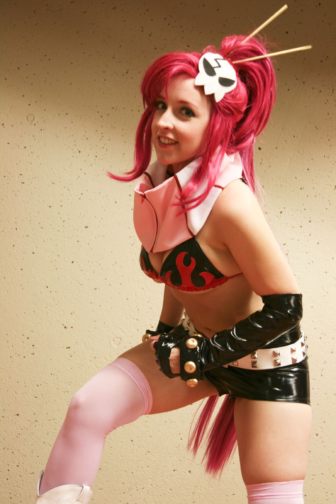 pamelaneko, yoko littner, tengen toppa gurren lagann, cosplay photo, photo (medium), 1girl, belt, bikini, bikini top only, breasts, cosplay, elbow gloves, female focus, gloves, leaning forward, long hair, medium breasts, red hair, scarf, shorts, solo, swimsuit, thighhighs, thighs, very long hair