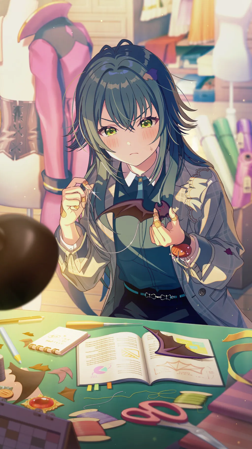 tsukimura temari, gakuen idolmaster, idolmaster, game cg, highres, official art, 1girl, bat wings, belt, book, buttons, frown, green eyes, green hair, open book, pen, pencil, scissors, sewing, solo, table, unworn clothes, wings