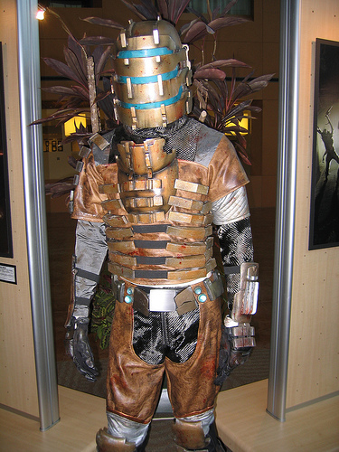 isaac clarke, dead space (series), lowres, photo (medium), 1boy, armor, cosplay, gun, male focus, power armor, power suit, science fiction, solo, weapon