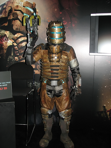 isaac clarke, dead space (series), lowres, photo (medium), 1boy, armor, cosplay, gun, indoors, male focus, power armor, power suit, solo, weapon