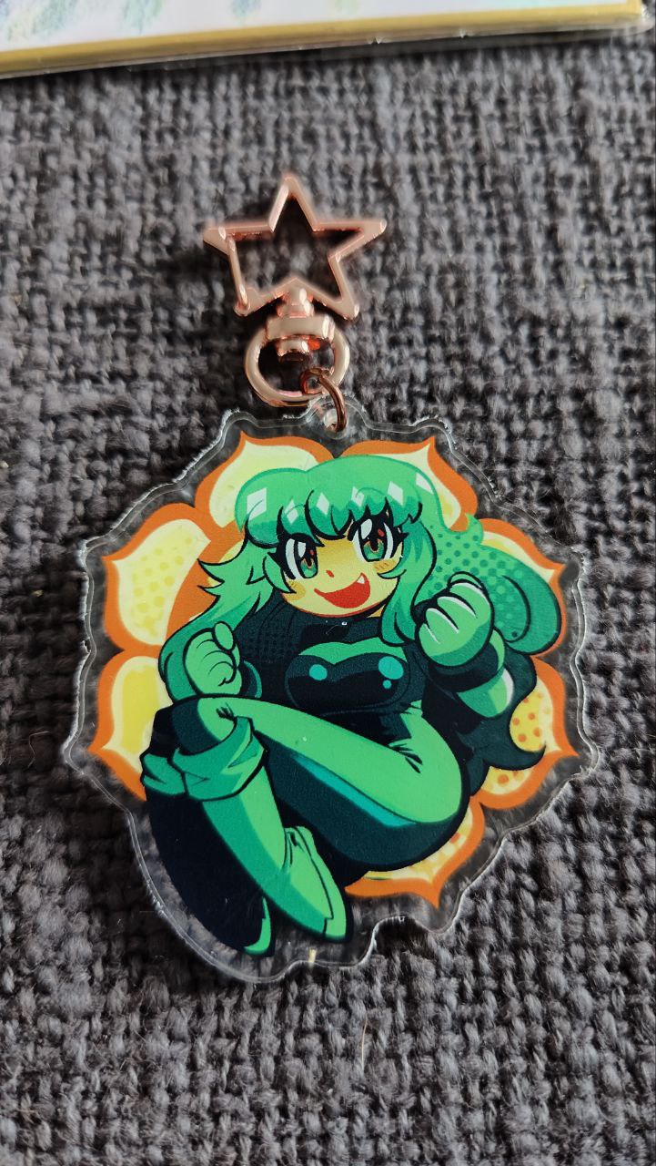 mogy64, dori (zeroranger), zeroranger, commentary, english commentary, highres, photo (medium), second-party source, traditional media, 1girl, asymmetrical footwear, black bodysuit, black boots, blush, bodysuit, boots, breasts, charm (medium), clenched hands, fang, flower, full body, gift art, green bodysuit, green boots, green eyes, green hair, green theme, halftone, happy, long hair, looking at viewer, lotus, medium breasts, mismatched footwear, multicolored bodysuit, open mouth, orange theme, smile, solo, star (symbol), two-tone bodysuit