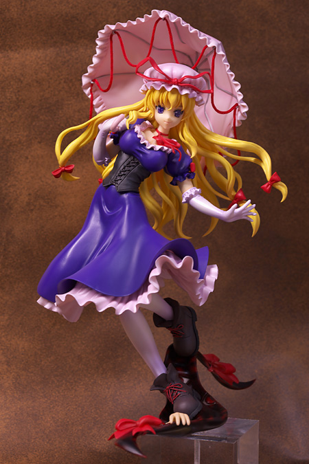 yakumo yukari, touhou, photo (medium), 1girl, blonde hair, boots, breasts, choker, cleavage, corset, female focus, figure, figure (medium), gap (touhou), gloves, hair ribbon, hat, large breasts, long hair, pantyhose, parasol, purple eyes, ribbon, solo, umbrella