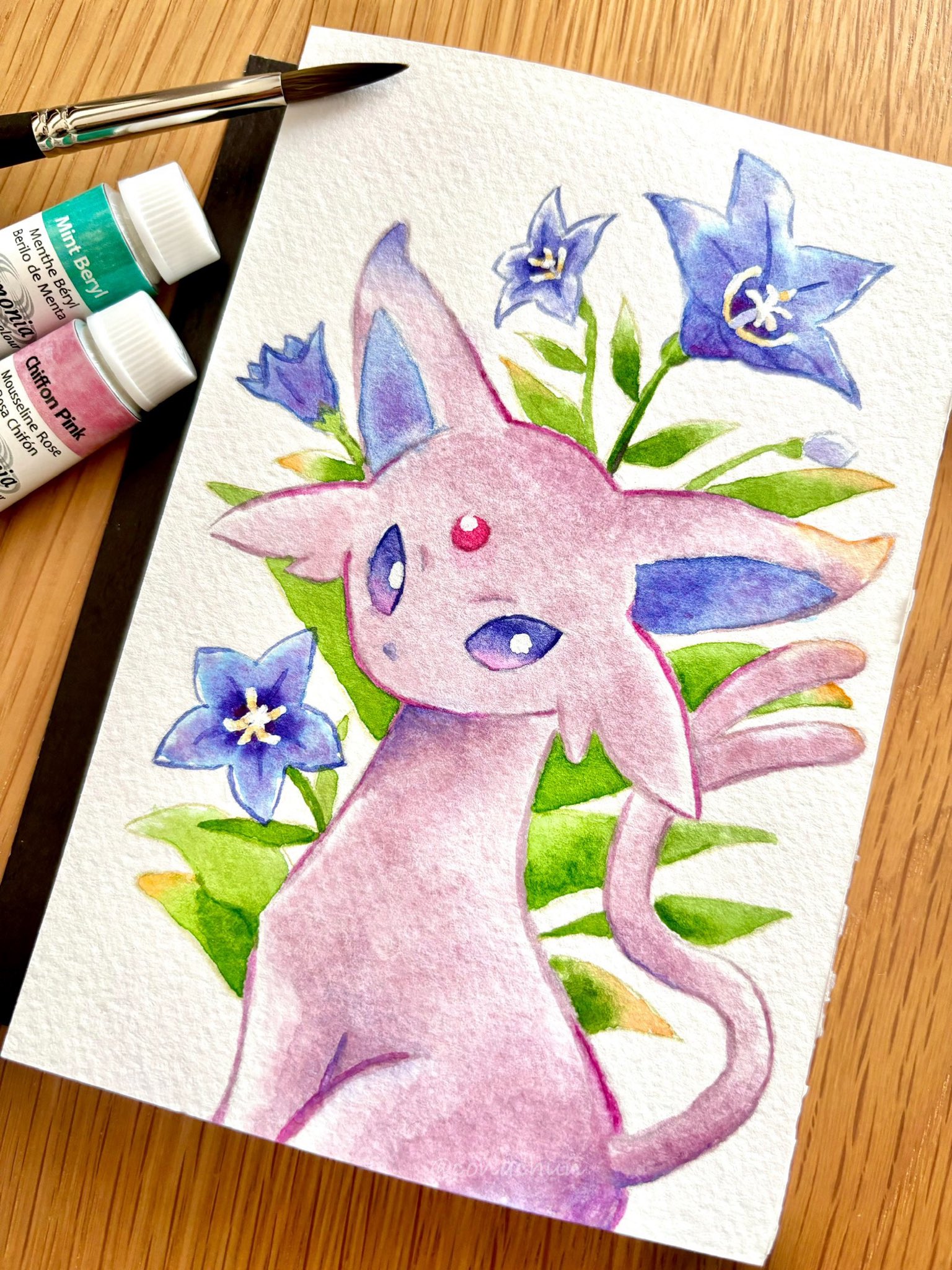 conachun, espeon, nintendo, pokemon, commentary request, highres, photo (medium), traditional media, art tools in frame, blue flower, bright pupils, creature, creature focus, flower, forehead jewel, forked tail, gen 2 pokemon, looking at viewer, no humans, pokemon (creature), pokemon focus, purple eyes, solo, tail, white pupils