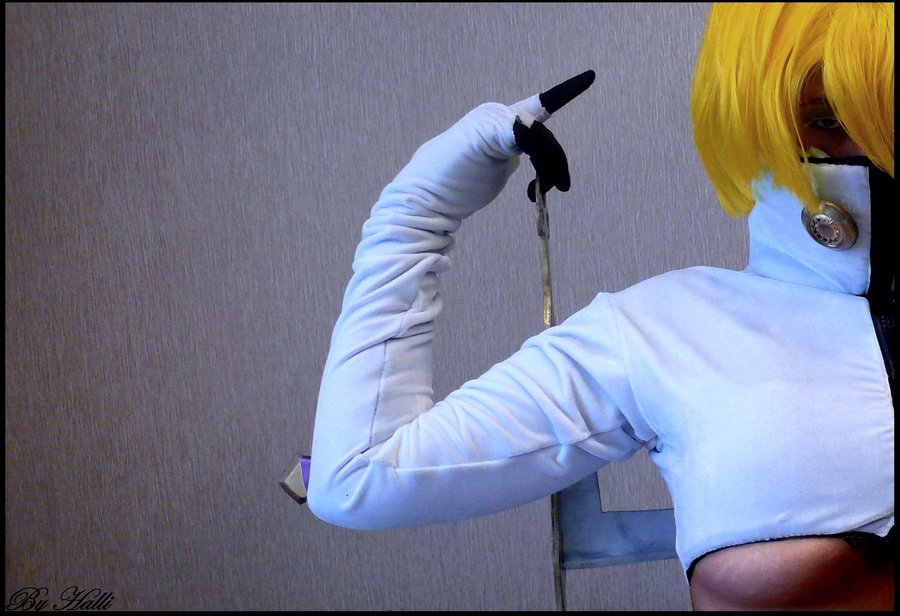 tier harribel, bleach, cosplay photo, photo (medium), 1girl, arrancar, blonde hair, breasts, cosplay, female focus, hollow (bleach), large breasts, midriff, number tattoo, solo, tattoo, tier harribel (cosplay), underboob, wig