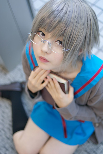 nagato yuki, suzumiya haruhi no yuuutsu, cosplay photo, photo (medium), 1girl, black socks, book, cardigan, cosplay, female focus, glasses, grey hair, kneehighs, school uniform, short hair, socks, solo