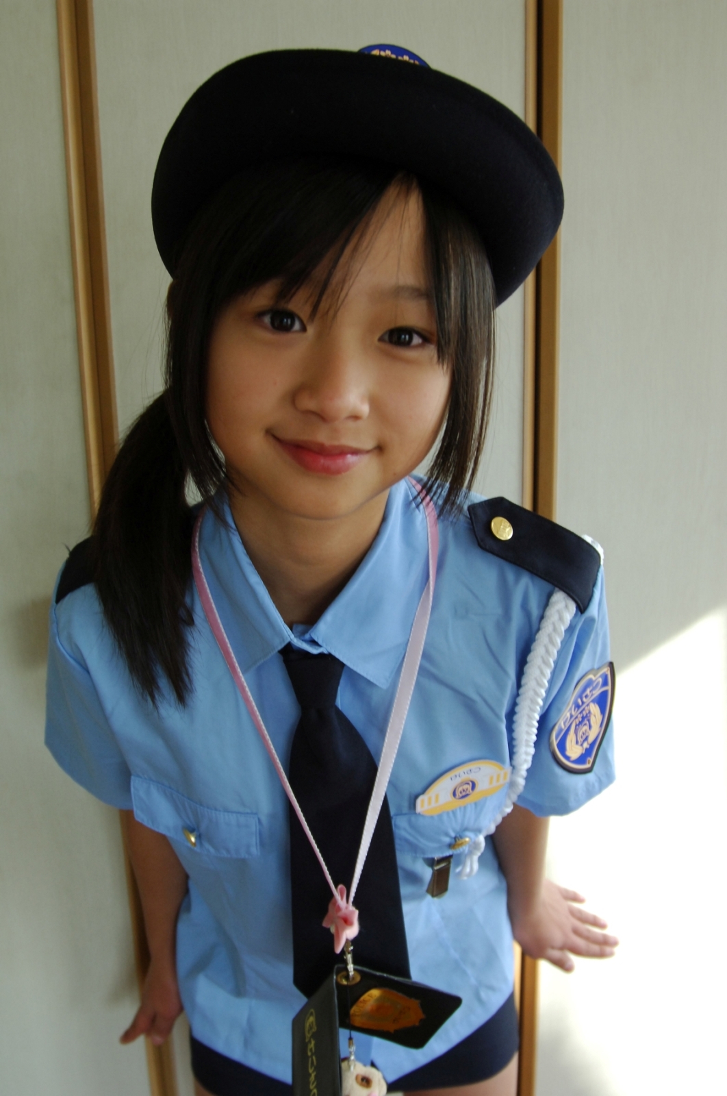 niino momoe, highres, photo (medium), 1girl, asian, black eyes, black hair, blue shirt, female focus, looking at viewer, necktie, police, police uniform, policewoman, shirt, solo