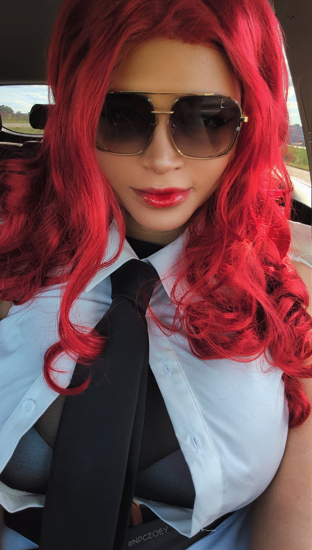 npczoey, crimson viper, capcom, real life, street fighter, street fighter 6, cosplay photo, photo (medium), 1girl, artist name, black gloves, black necktie, breasts, car interior, closed mouth, coat, cosplay, crimson viper (cosplay), dark-skinned female, dark skin, female focus, gloves, large breasts, long hair, looking at viewer, necktie, red hair, red lips, smile, solo, twitter username, vehicle interior, white coat