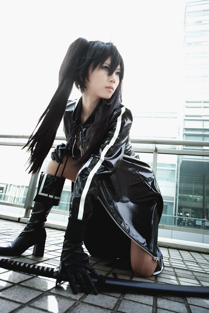 black rock shooter, cosplay photo, photo (medium), 1girl, belt, bikini, bikini top only, black hair, braid, cosplay, female focus, hood, hooded jacket, jacket, katana, long hair, short shorts, shorts, solo, swimsuit, sword, twin braids, weapon