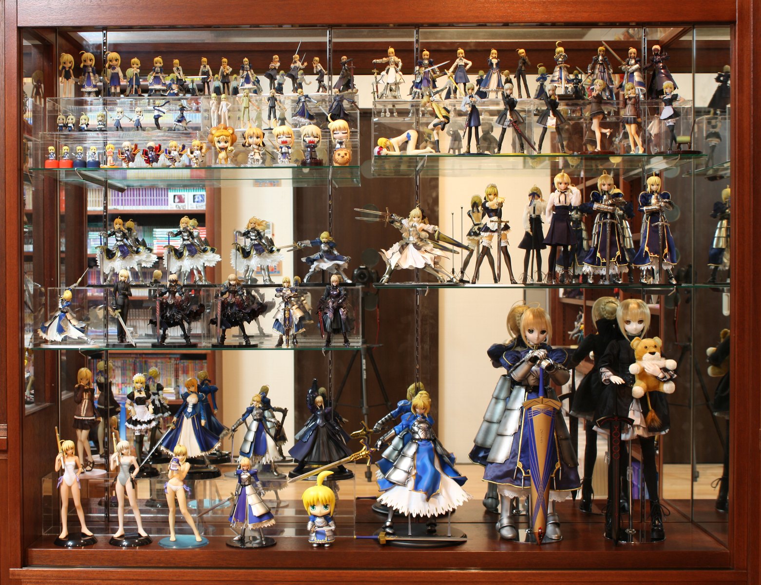 artoria pendragon (fate), avalon (fate), pon de lion, saber (fate), saber alter, saber lily, saber lion, capcom, fate/stay night, fate/tiger colosseum, fate/unlimited codes, fate/zero, fate (series), figma, mister donut, nendoroid, type-moon, highres, photo (medium), 6+girls, ahoge, armor, armored dress, bikini, blonde hair, caliburn (fate), casual, chibi, coat, collection, dress, excalibur (fate/stay night), excalibur morgan (fate), figure, food, formal clothes, fruit, green eyes, lion, maid, mirror, multiple girls, one-piece swimsuit, otaku room, pantyhose, ponytail, ribbon, scarf, sheath, shinai, skirt, stuffed animal, stuffed toy, suit, swimsuit, sword, thighhighs, watermelon, weapon, zettai ryouiki